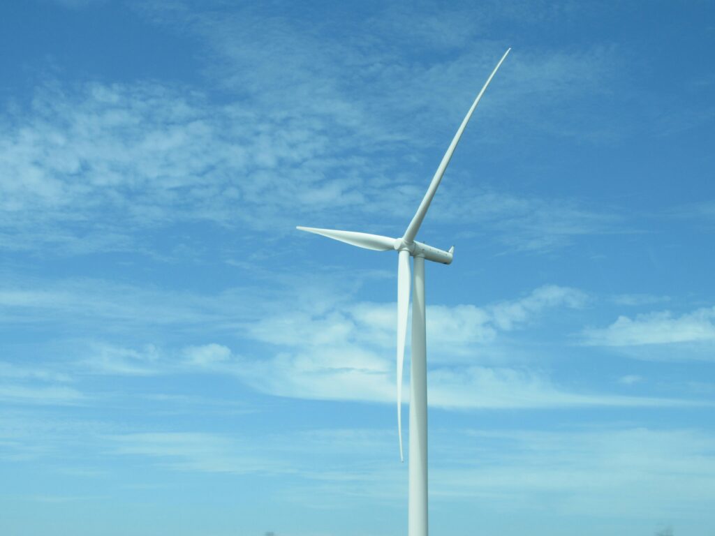 White windmill for energy and the environment in front of a blue sky