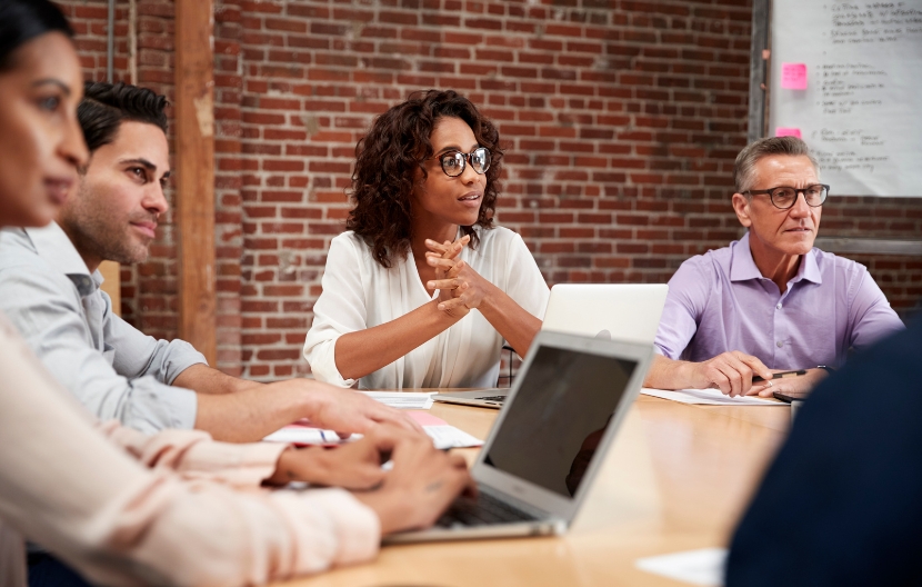 Team members sat around a meeting table