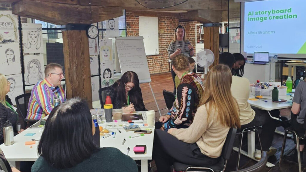 Alina is wearing a striped top and giving a presentation to a group at the Made Tech London office.